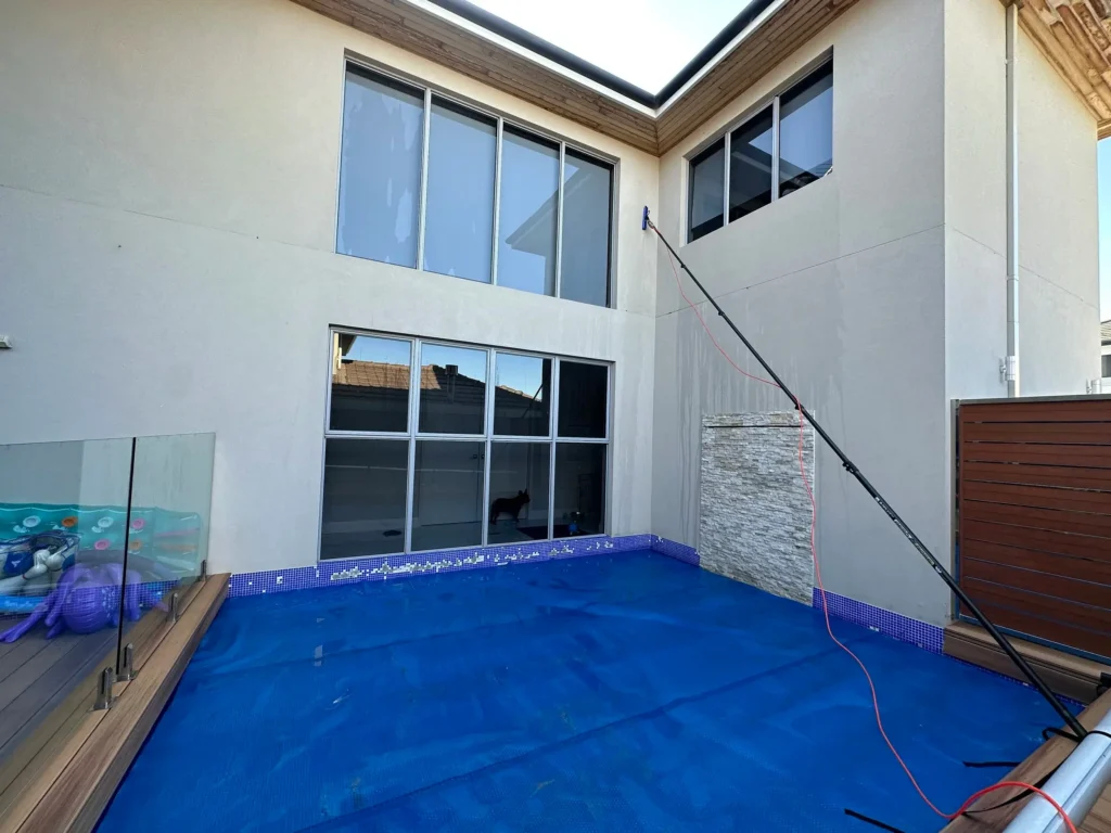 Window cleaning above a pool in North Coogee, Perth